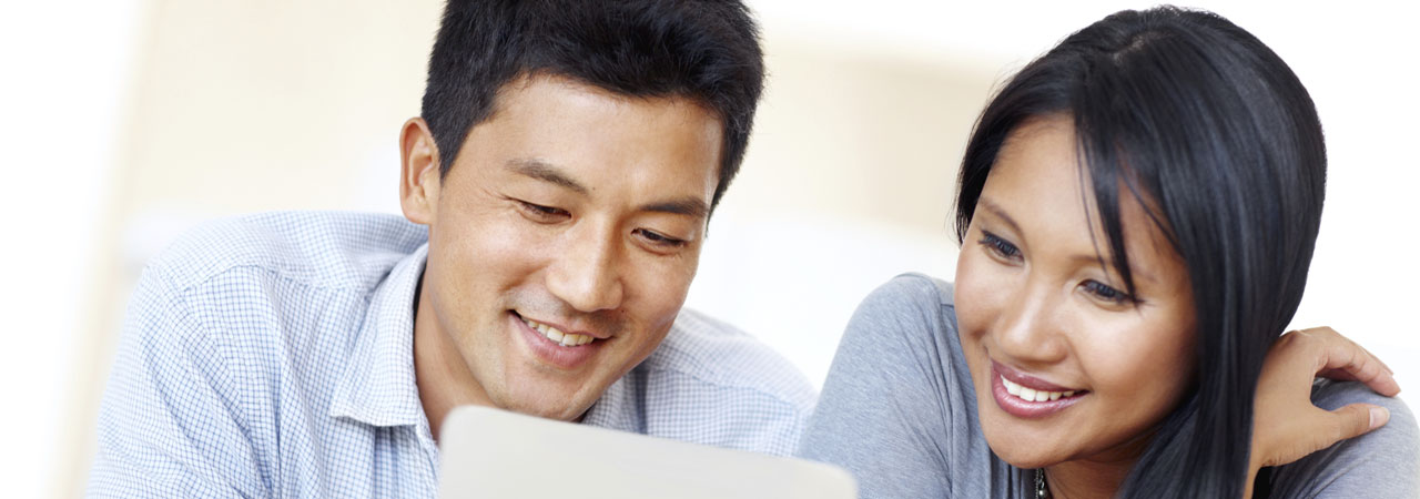 man and woman using a tablet